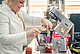 Doctoral candidate Natalie Feller portions the bread dough with alternative proteins instead of gluten into the mini loaf pans for the baking line 30g at a time. | Image source: University of Hohenheim / Oliver Reuther