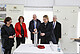 Time capsule for the foundation stone of the future animal science research center HoLMiR: Prof. Dr. Jana Seifert deposits a bezoar stone into the steel cylinder. Bezoars are balls of animal hair and other foreign bodies that accumulate in animals’ stomachs. The capsule also included coins, deposited by State Secretary Gisela Splett (Ministry of Finance BaWü, wearing a red jacket), building plans and a current daily newspaper, deposited by Ministerial Director Dr. Hans J. Reiter (Ministry of Science BaWü, to the right of Splett), and the Hohenheim guidelines for animal experiments, deposited by University President Prof. Dr. Stephan Dabbert (to the right of Reiter). Pictured on the left: Carmen Zinnecker-Busch, from the Stuttgart and Hohenheim University Building Office. Image: University of Hohenheim/Beqiri
