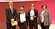 Bei der der Preisverleihung (von links): Moderator Jon Abele (Partner und Leiter des Geschäftsbereichs Öffentliche Auftraggeber, BearingPoint), Ulrich Forster (KIM, Universität Hohenheim), Friederike Hoffmann (Abteilung Hochschuldidaktik, Universität Hohenheim), Prof. Dr. Maria A. Wimmer (Jury-Mitglied) | Quelle: @BaeringPoint
